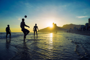Am Strand von Ipanema an der Küste von Rio de Janeiro, Brasilien, trifft sich zum Plaudern, Fußball-, Volleyball- oder Footvolleyspiel