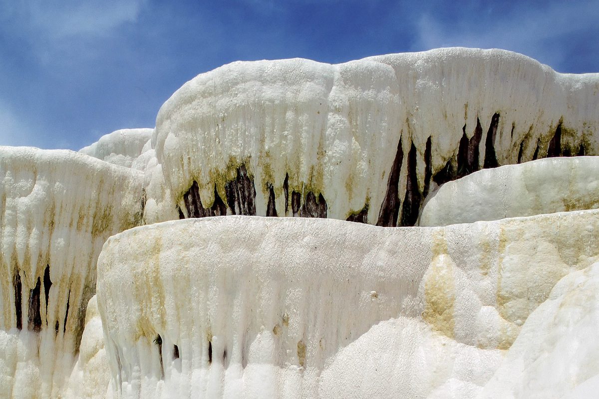 The water in the snow-white basins of Pamukkale has solidified waterfalls and streams over time, Turkey - © Alaettin YILDIRIM / Shutterstock